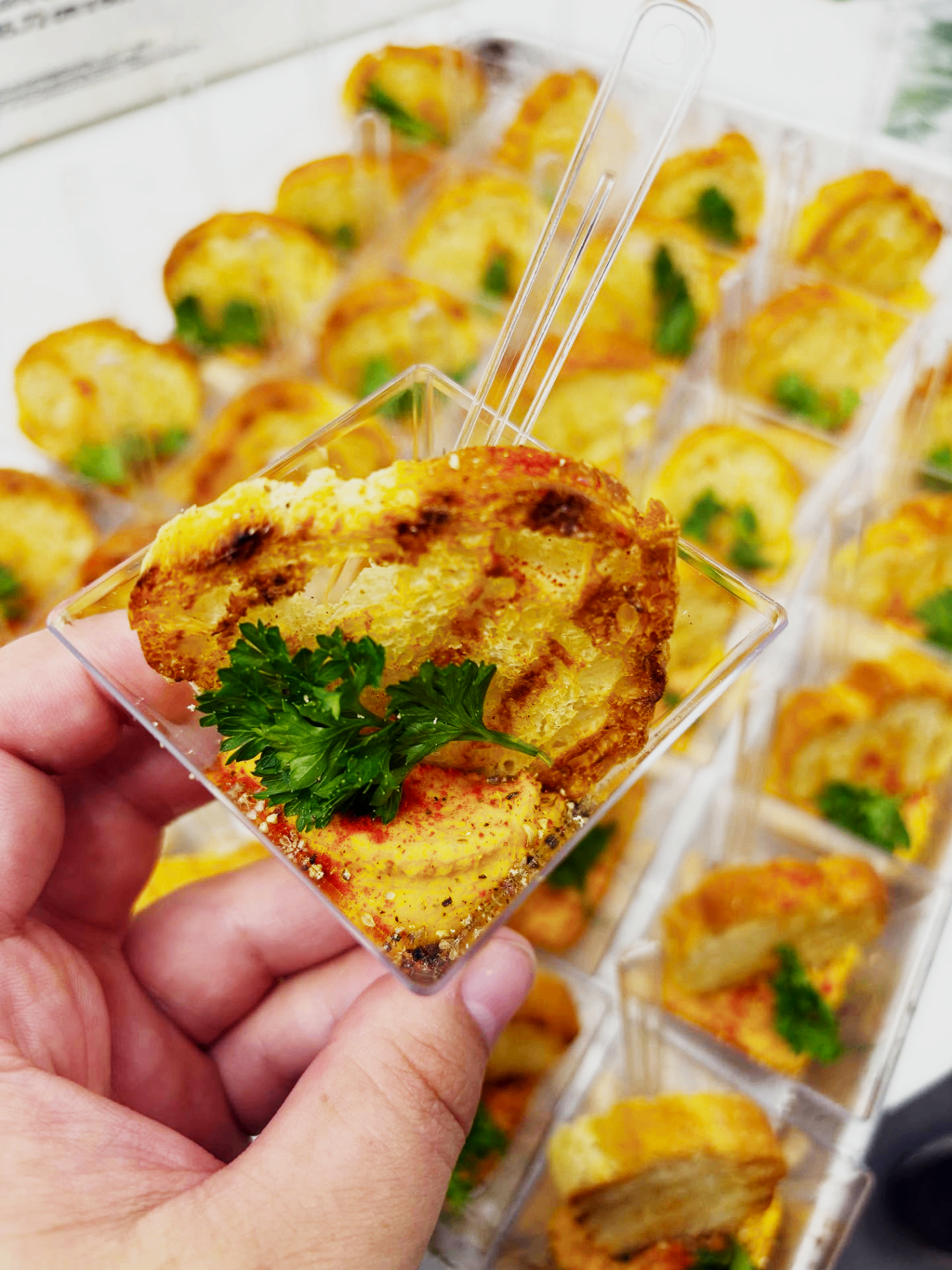 Bite-sized appetizer cups with toasted bread and herbs