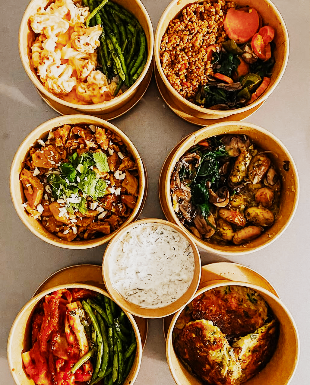 Prepared home-style meal prep bowls arranged overhead